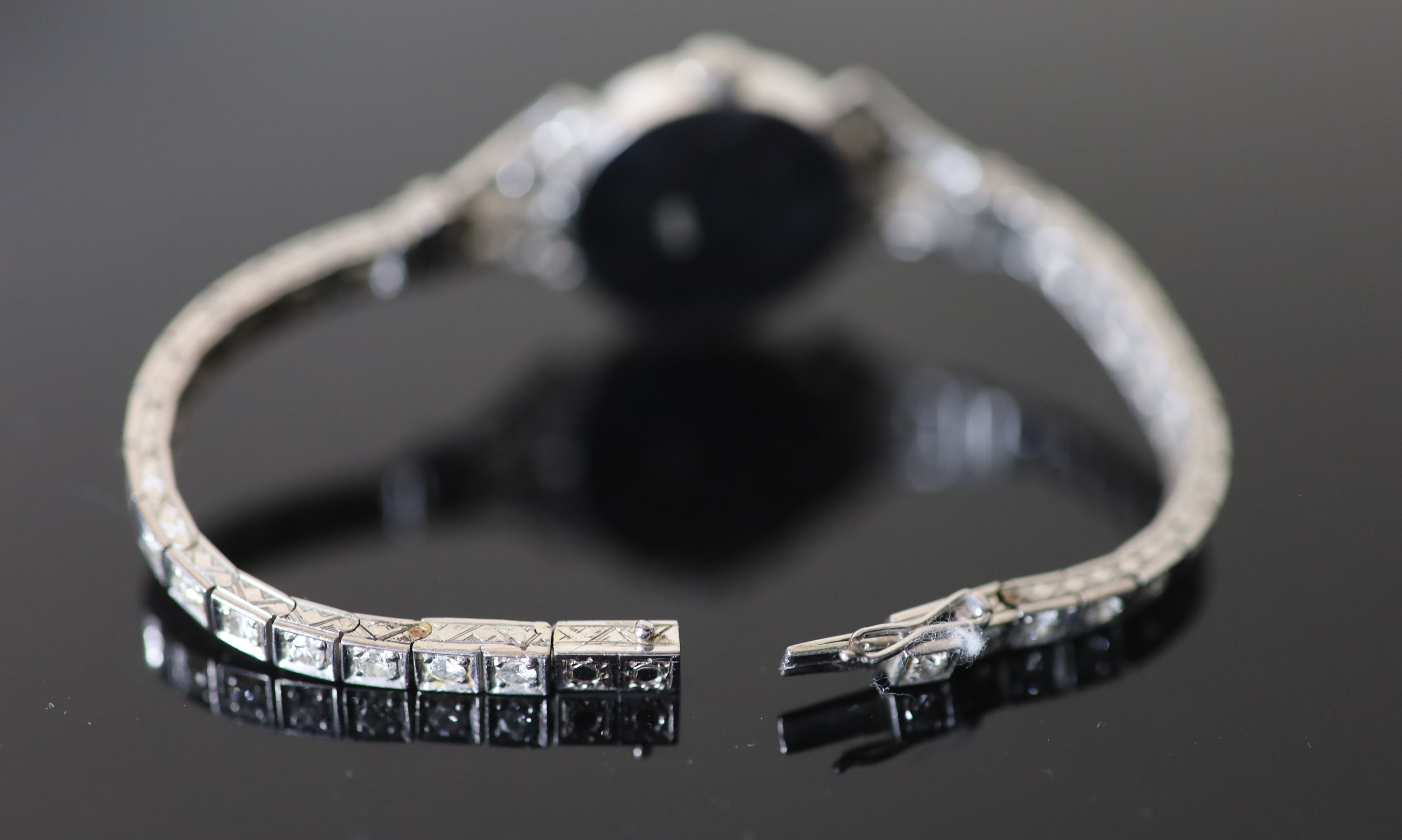 A ladys early 1960s 18ct gold, palladium and diamond set Omega manual wind cocktail watch, on diamond set bracelet,